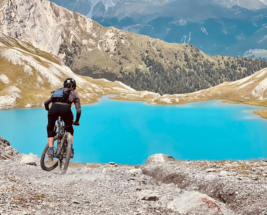 man in black jacket riding bicycle on mountain during daytime