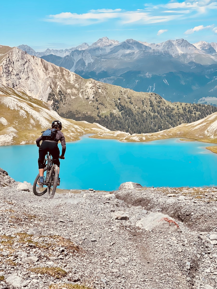 man in black jacket riding bicycle on mountain during daytime